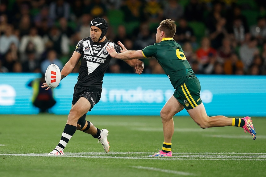 A man puts a kick in during a rugby league match