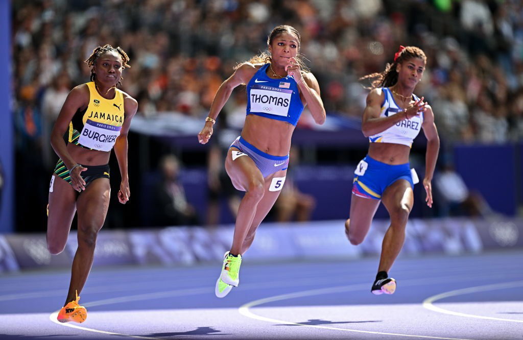 Gabby Thomas runs ahead in her 200m heat at the Paris Olympics.