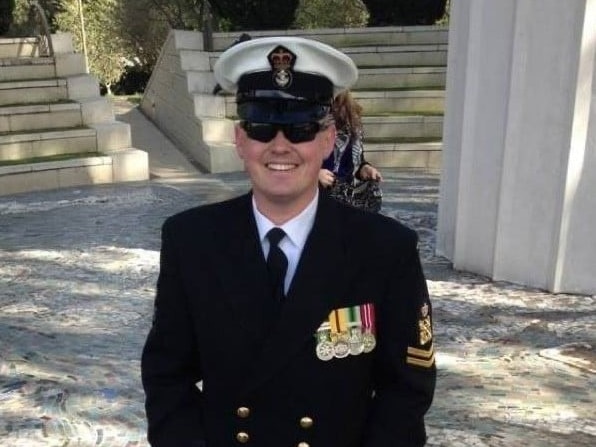 A man wearing a navy uniform and medals