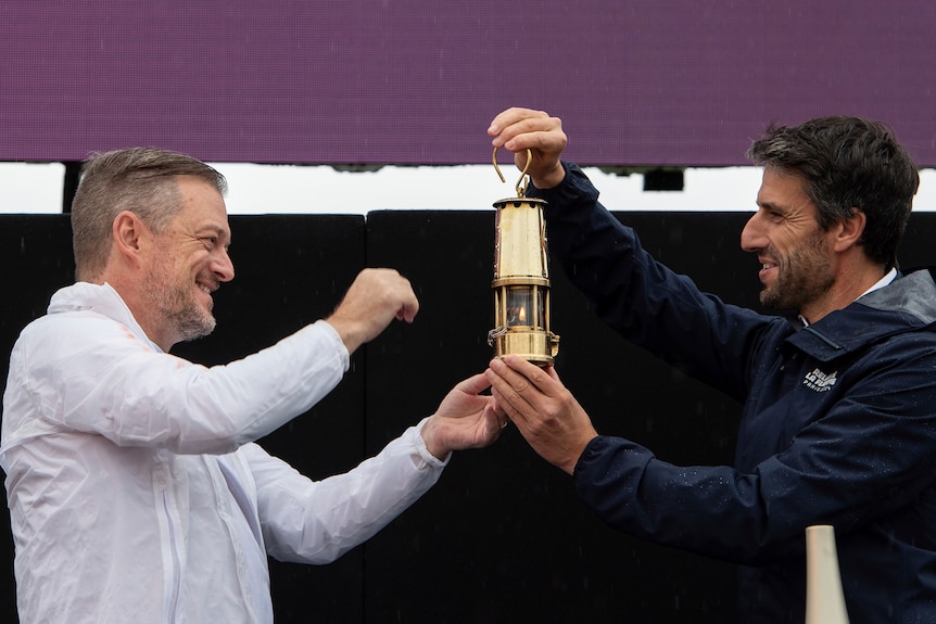 Andrew Parsons and Tony Estanguet with the Paralympic Flame.