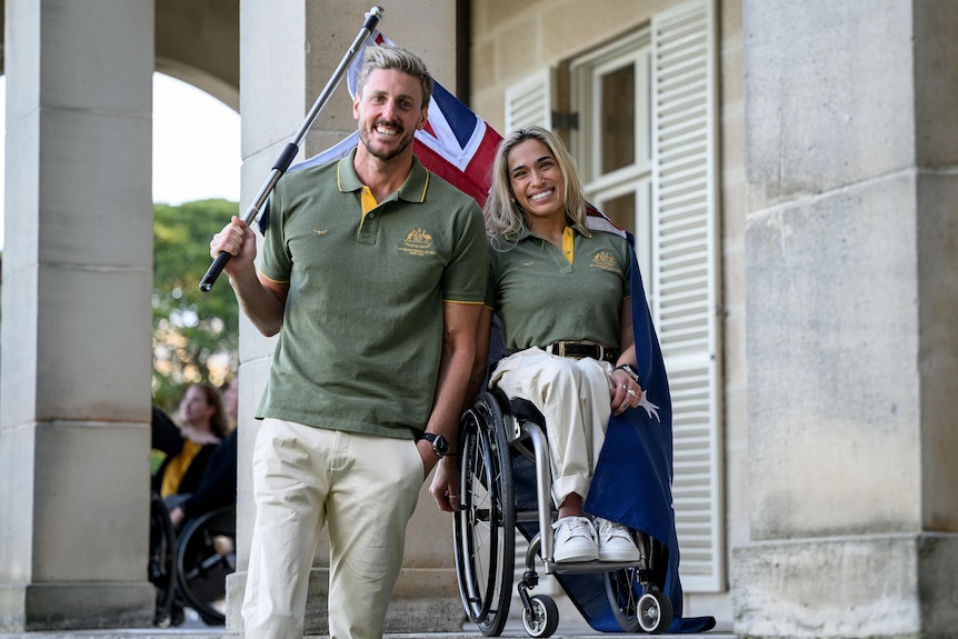 Brenden Hall and Madison de Rozario together with the Australian flag.