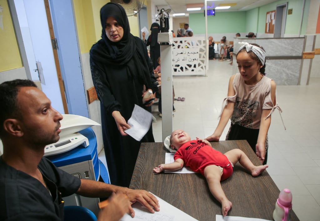A Palestinian infant is examined by a doctor at Nasser Hospital in Khan Younis, southern Gaza, as United Nations officials are preparing to launch a polio vaccination campaign on Sunday that will rely on a series of limited pauses in fighting between Israeli forces and Hamas. Photo: Reuters