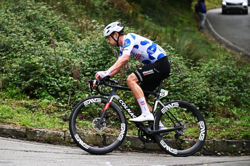 Jay Vine rides his bike in the polka dot jersey