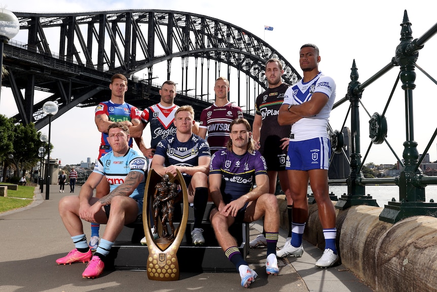 NRL captains pose in front of the harbour bridge with the NRL premiership trophy