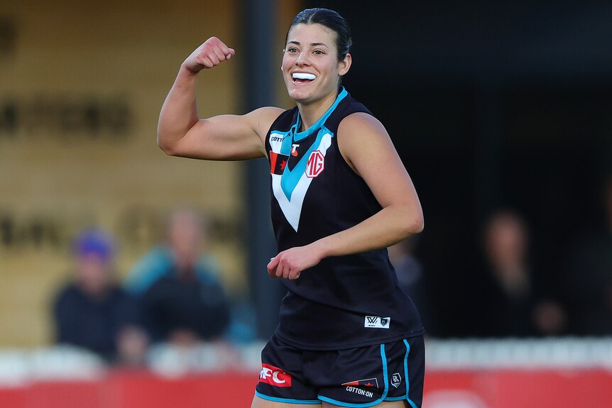 Julia Teakle pumps her right fist as she celebrates an AFLW goal for Port Adelaide.