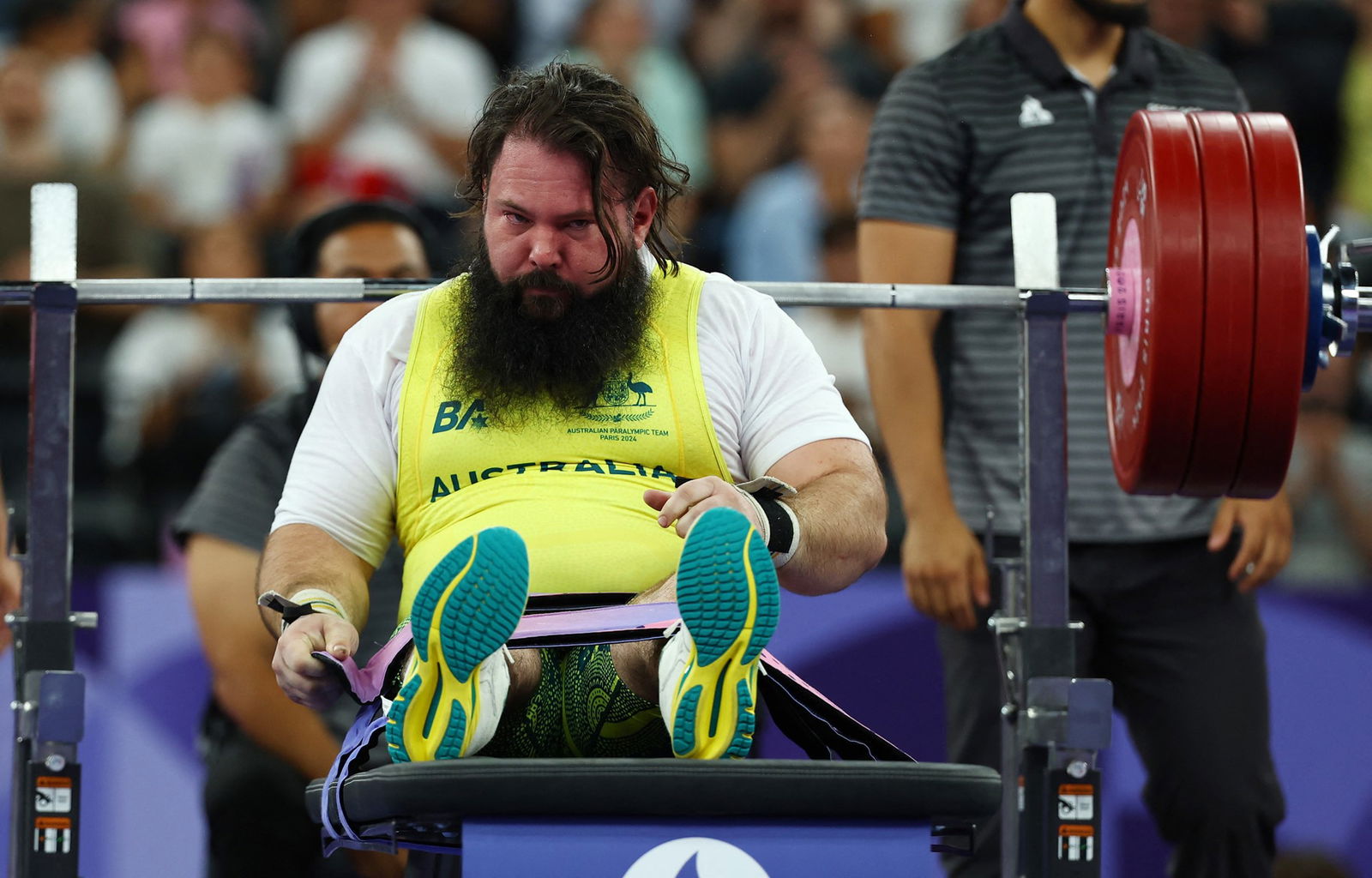 Australian Para powerlifter Ben Wright, sits on the bench after a lift. He has a long, bushy brown beard.