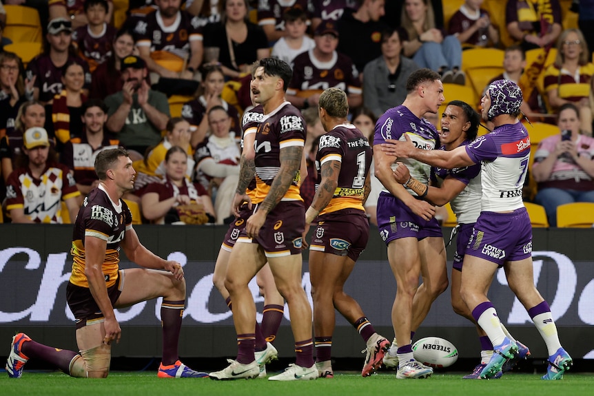 Will Warbrick celebrates a try as Broncos players look on