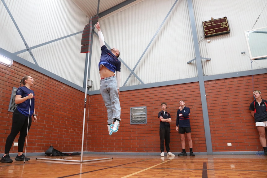 Kyle Chalmers jumping while kids look on 