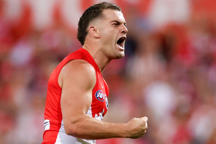 Tom Papley screams out as he celebrates a goal during AFL preliminary final.