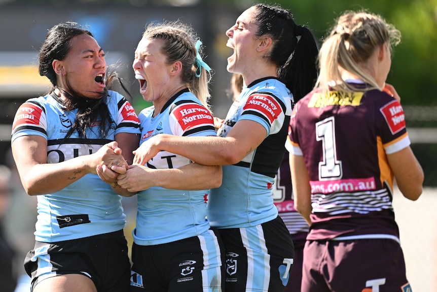 Sharks NRLW players celebrate a try against Brisbane Broncos.