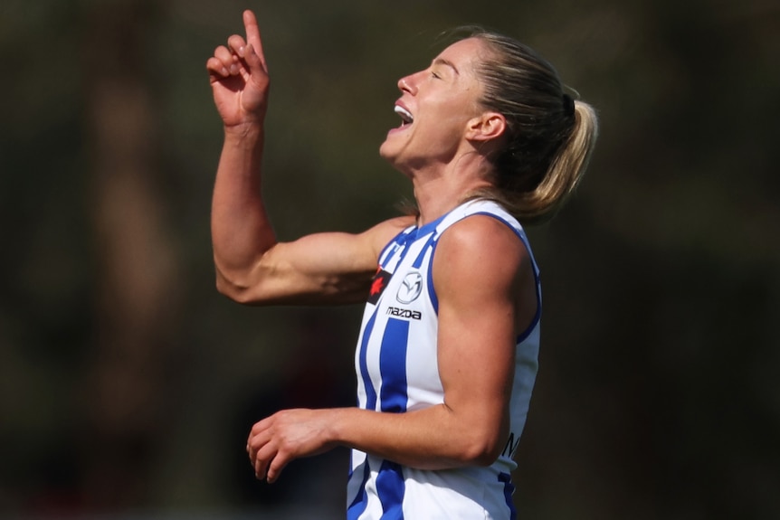 Alice O'Loghlin celebrates a North Melbourne goal against Melbourne.