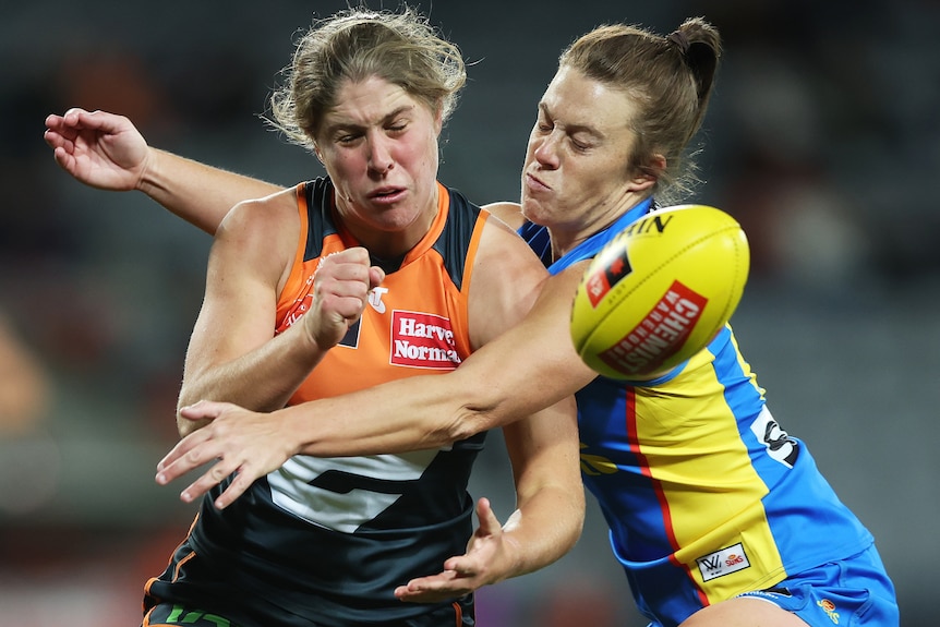 Katherine Smith handballs for GWS against Gold Coast Suns.