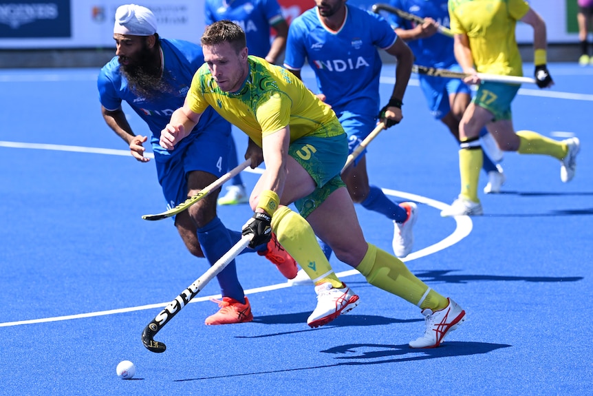 Tom Wickham of Australia and Jarmanpreet Singh battle for the ball in field hockey
