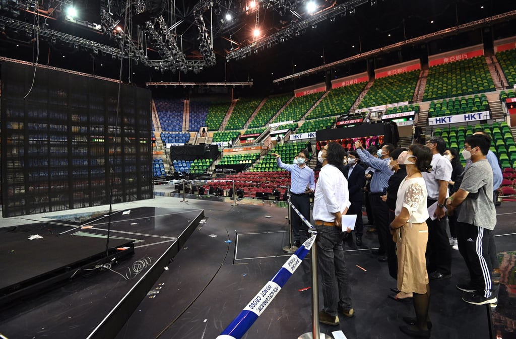 Authorities inspect the Hong Kong Coliseum. Police have charged three people from Engineering Impact with conspiracy to defraud in connection with the case. Photo: Handout Authorities inspect the Hong Kong Coliseum. Police have charged three people from Engineering Impact with conspiracy to defraud in connection with the case. Photo: Handout