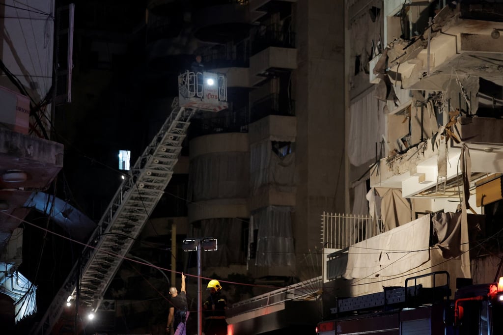 A rescuer stands next to a damaged building at the site of an Israeli air strike in Ras Al- Nabaa, Beirut, Lebanon on Thursday. Photo: Reuters