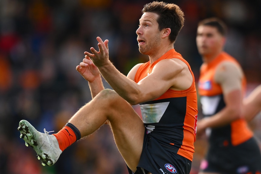 Toby Greene kicks during a GWS vs Hawthorn AFL match.