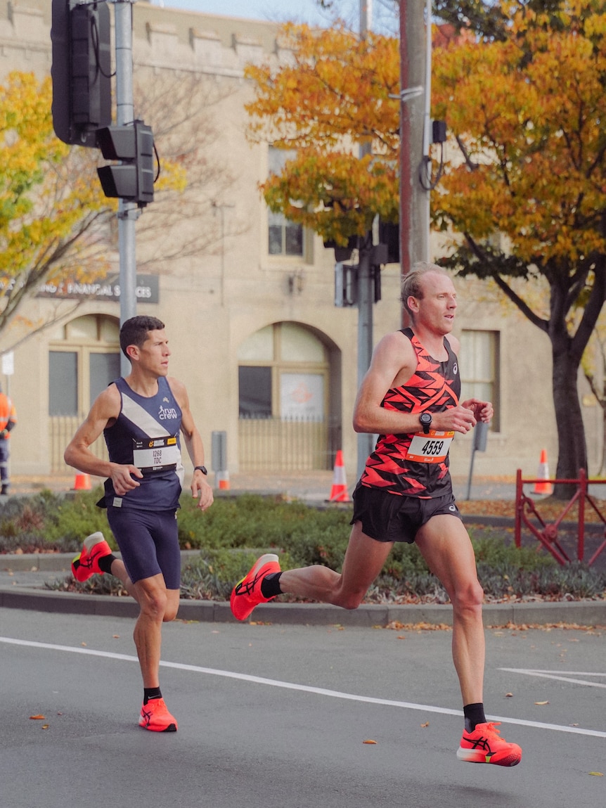 Reece in good form as he runs on a road past a bank as part of a distance event.