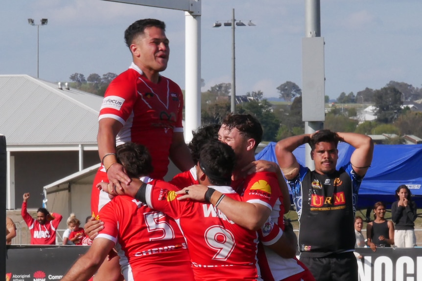 rugby league players celebrate a try