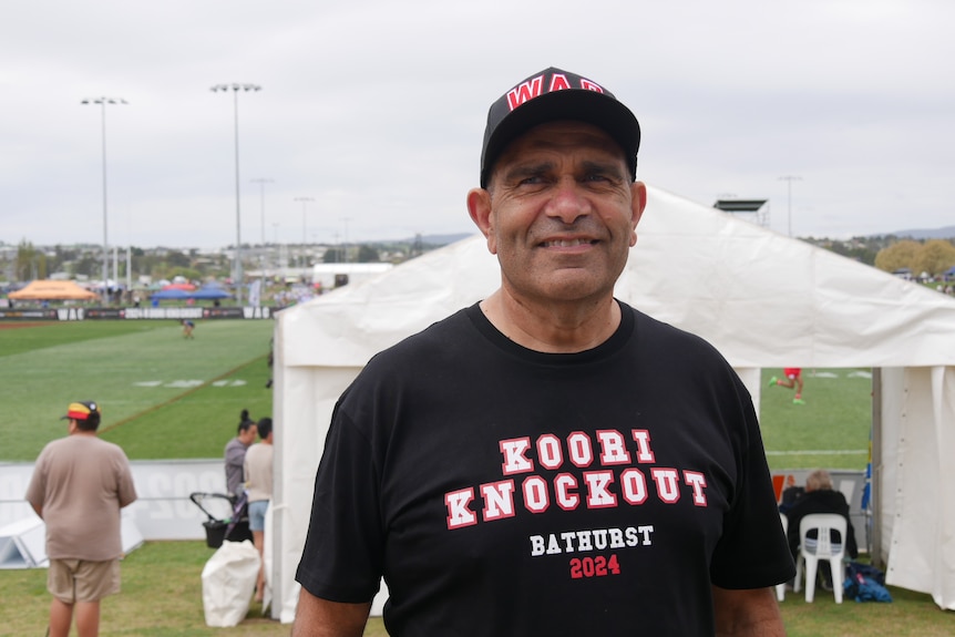 a man standing in front of a rugby league field