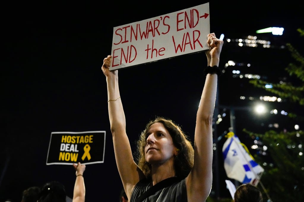 A demonstrator holds a sign about the killing of Hamas leader Yahya Sinwar during a protest in Tel Aviv, Israel, on Thursday. Photo: AP