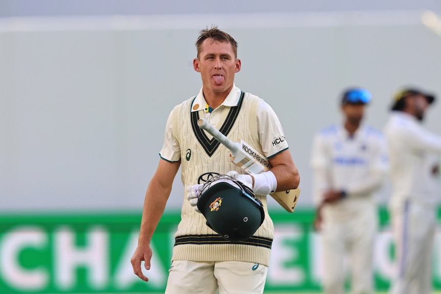 Australia batter Marnus Labuschagne sticks his out as he walks off the field in the first Test against India.