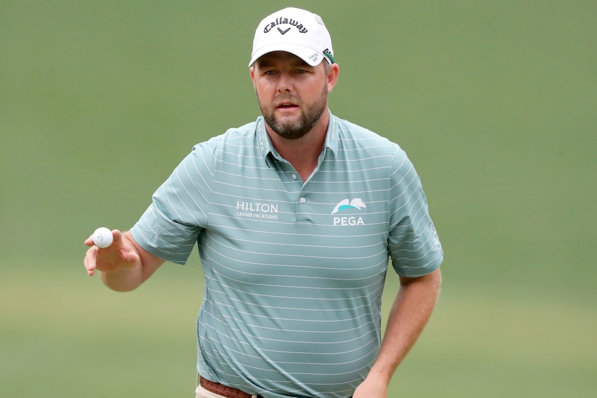 Marc Leishman holds his ball as he gestures to the crowd