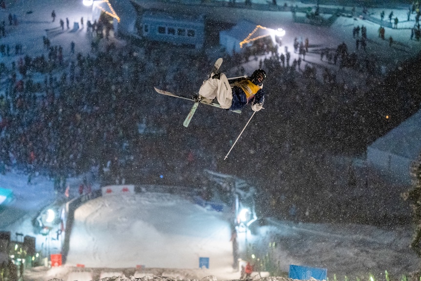 Jakara Anthony leaps in the air crossing her skis