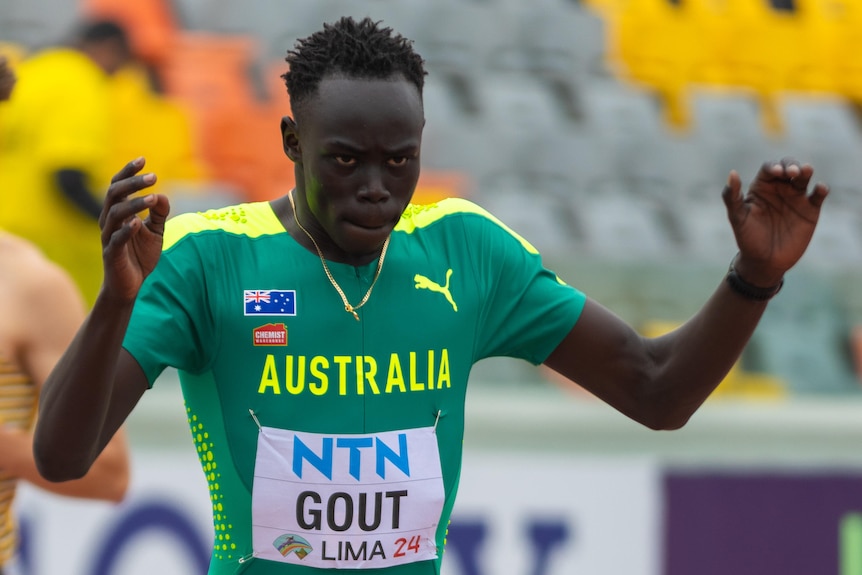 Gout Gout prepares to run holding his hands up in the air