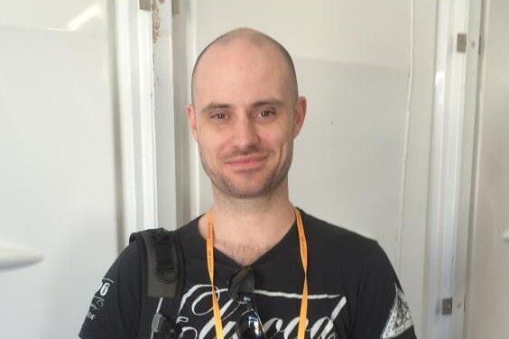 A photo of Gymnastics coach Jeb Silsbury. He is smiling in the photo