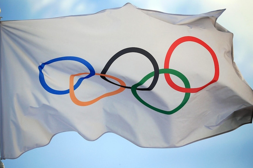 A white flag with the Olympic Games rings on it.