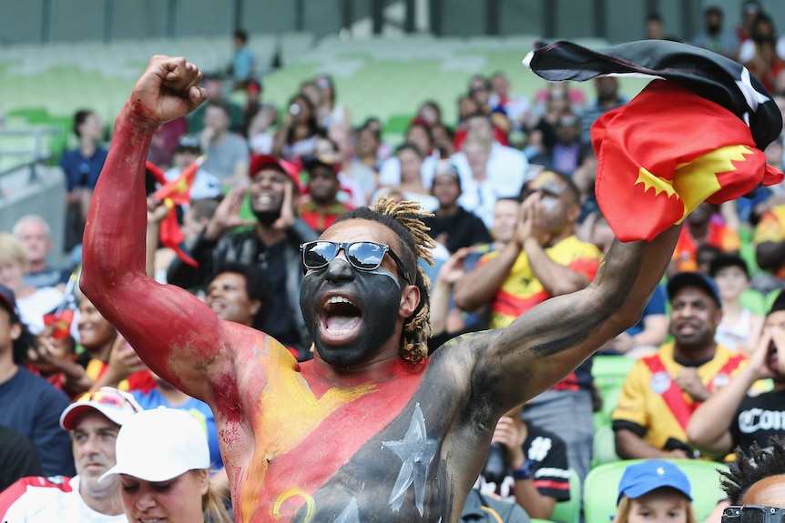 A fan celebrates a PNG try