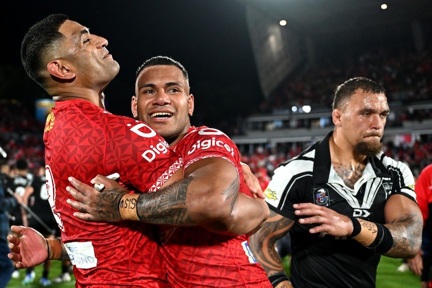 Daniel Tupou and Sione Katoa hug