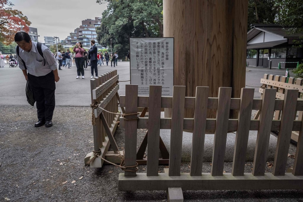 A man bows before he goes through a torii gate that has been fenced off at Meiji shrine. Photo: AFP