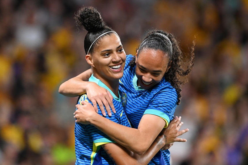 Amanda Gutierres celebrates with Aline Gomes