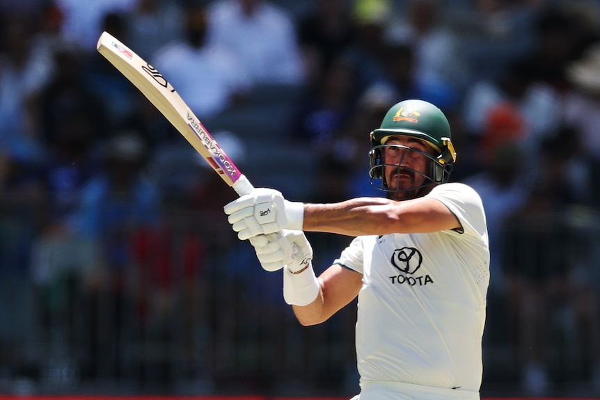 Mitch Starc swings the bat