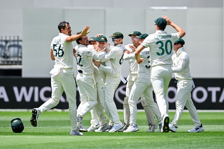 Australian players celebrates with Nathan McSweeny after he took a catch