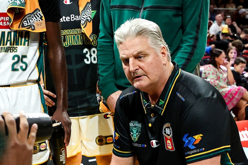 Scott Roth addressing players during a basketball match.
