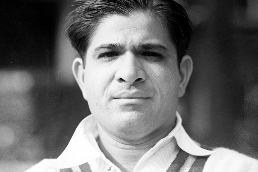 A black and white image of an Indian cricketer