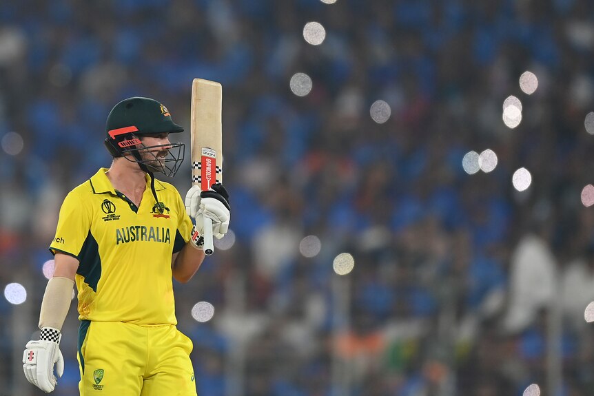 Travis Head holds up his bat