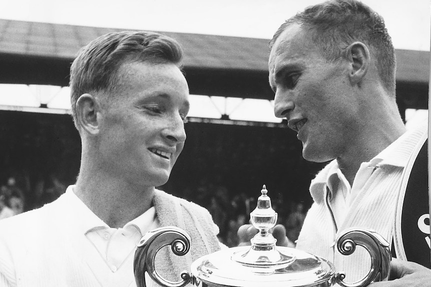Rod Laver (left) and Neale Fraser (right) with the Wimbledon singles trophy in 1960.