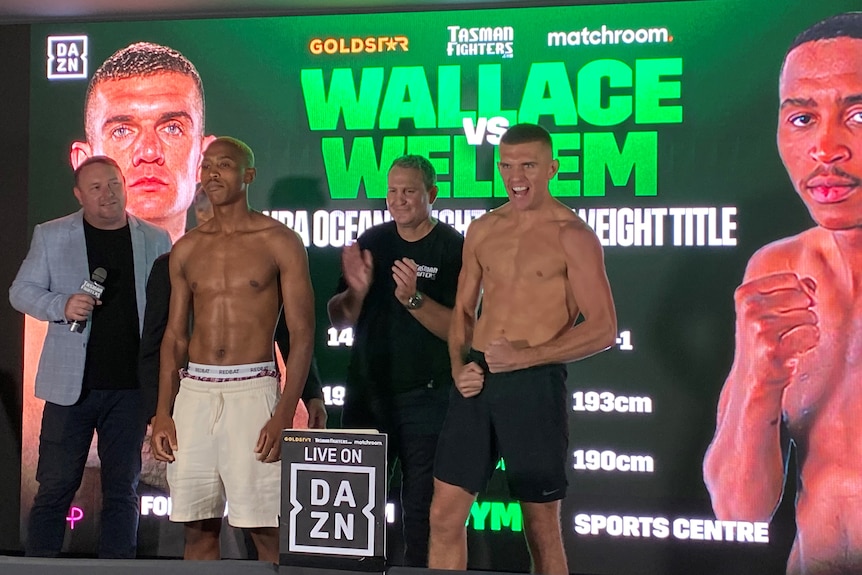 Conor Wallace gestures on a stage