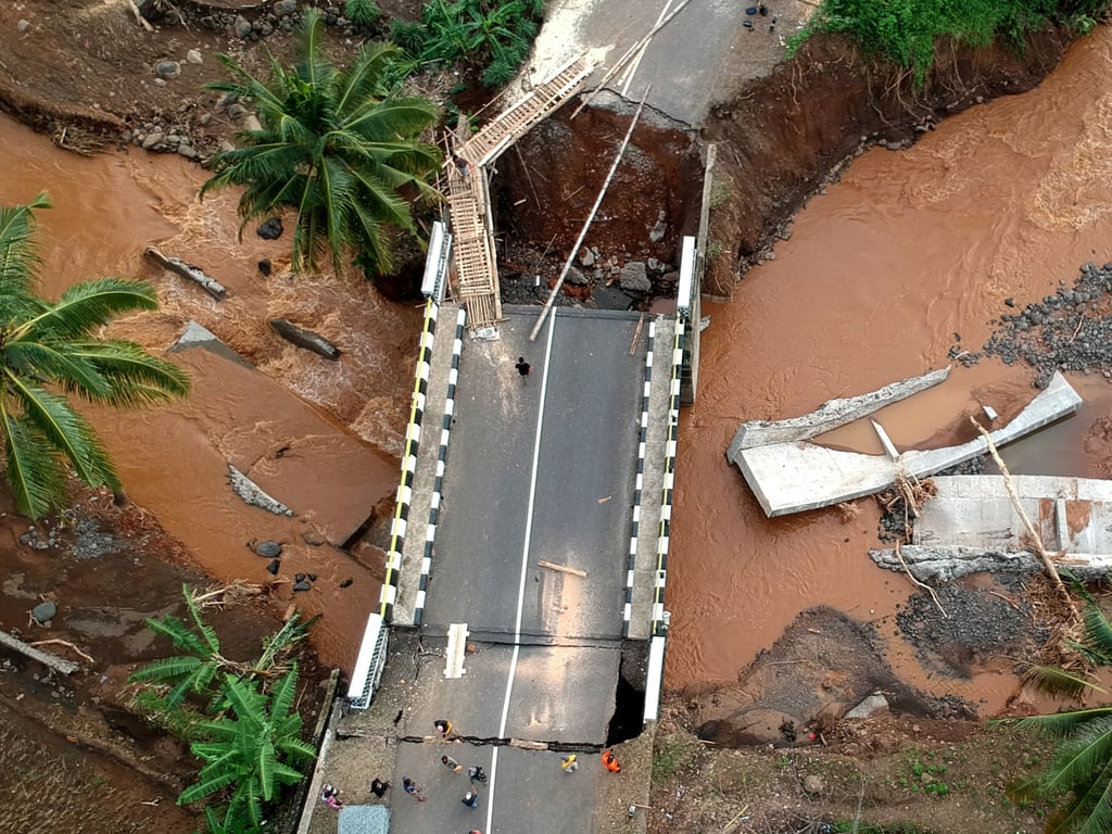 An aerial drone photo taken on Saturday shows a bridge damaged by floods at Cisarakan village in Indonesia’s West Java province. Photo: Xinhua