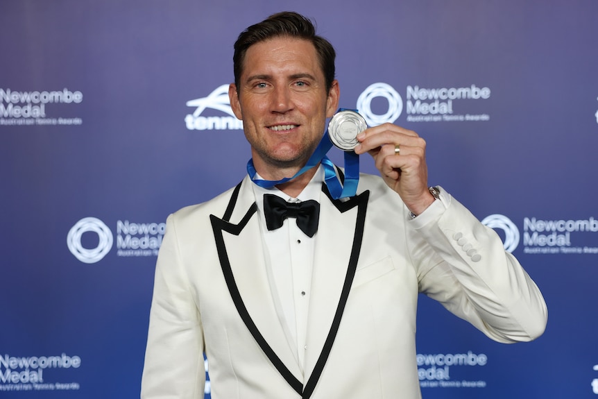 Matt Ebden poses with the John Newcombe medal