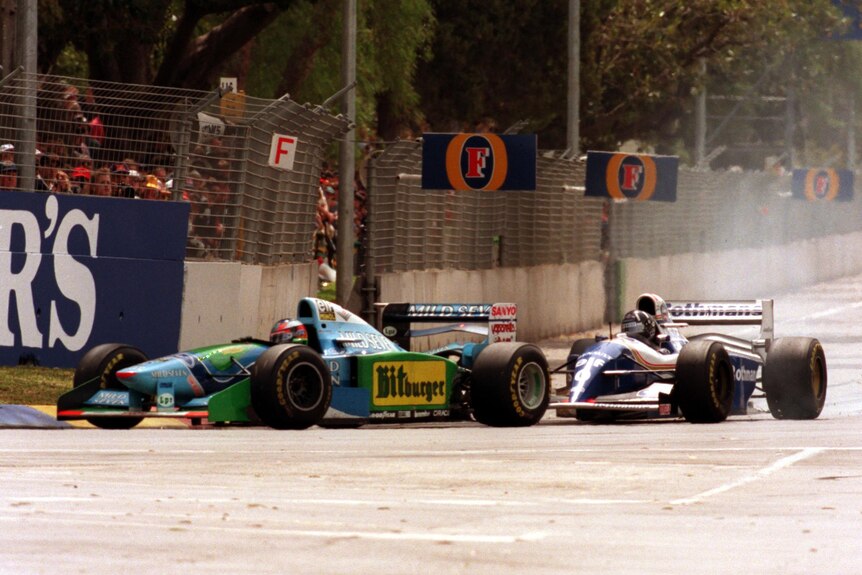 Damon Hill driving an F1 Williams locks his brakes chasing Michael Schumacher's Benetton at a street circuit.