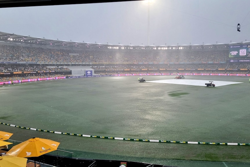 The Gabba is flooded by rain during the third Test between India and Australia.
