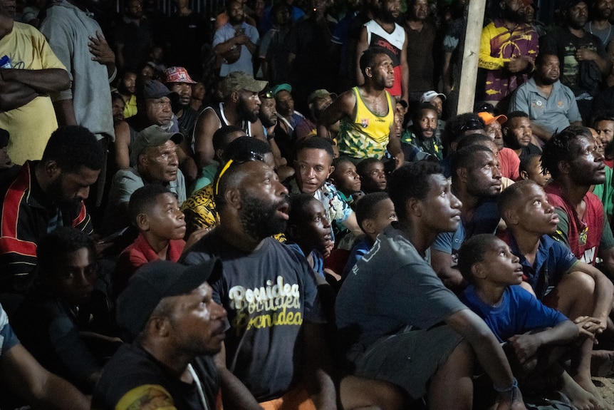 A group of people gathered to watch a sports match. 