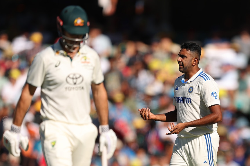 Ravi Ashwin looks confused as Mitch Marsh walks off the field with his head down