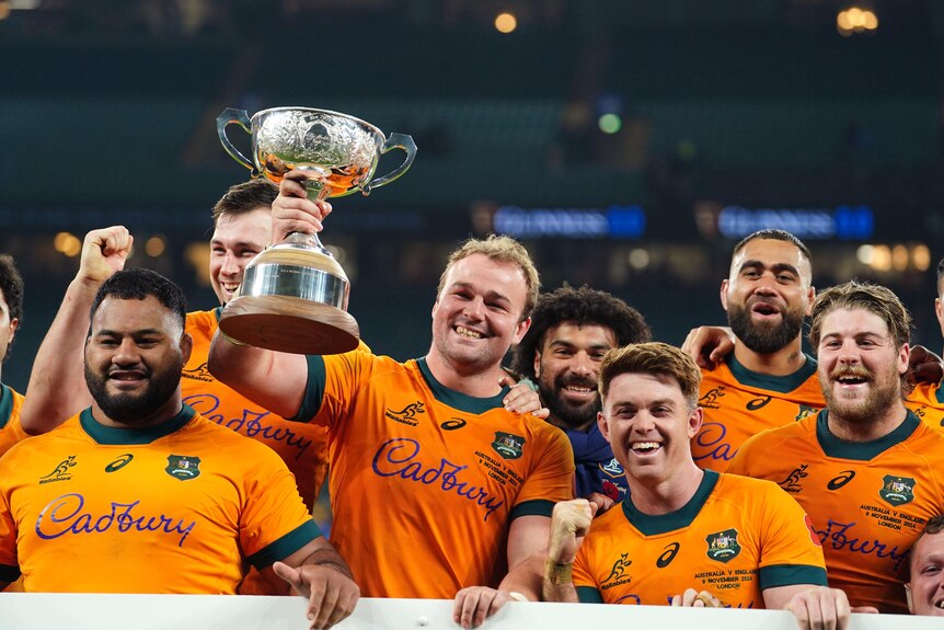 Harry Wilson holds up the Ella-Mobbs trophy