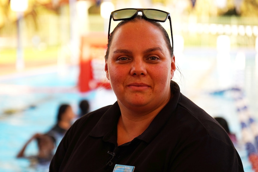 A close of woman with sunglasses on her head