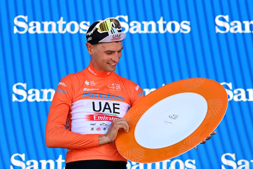Jay Vine looks at the Tour Down Under trophy